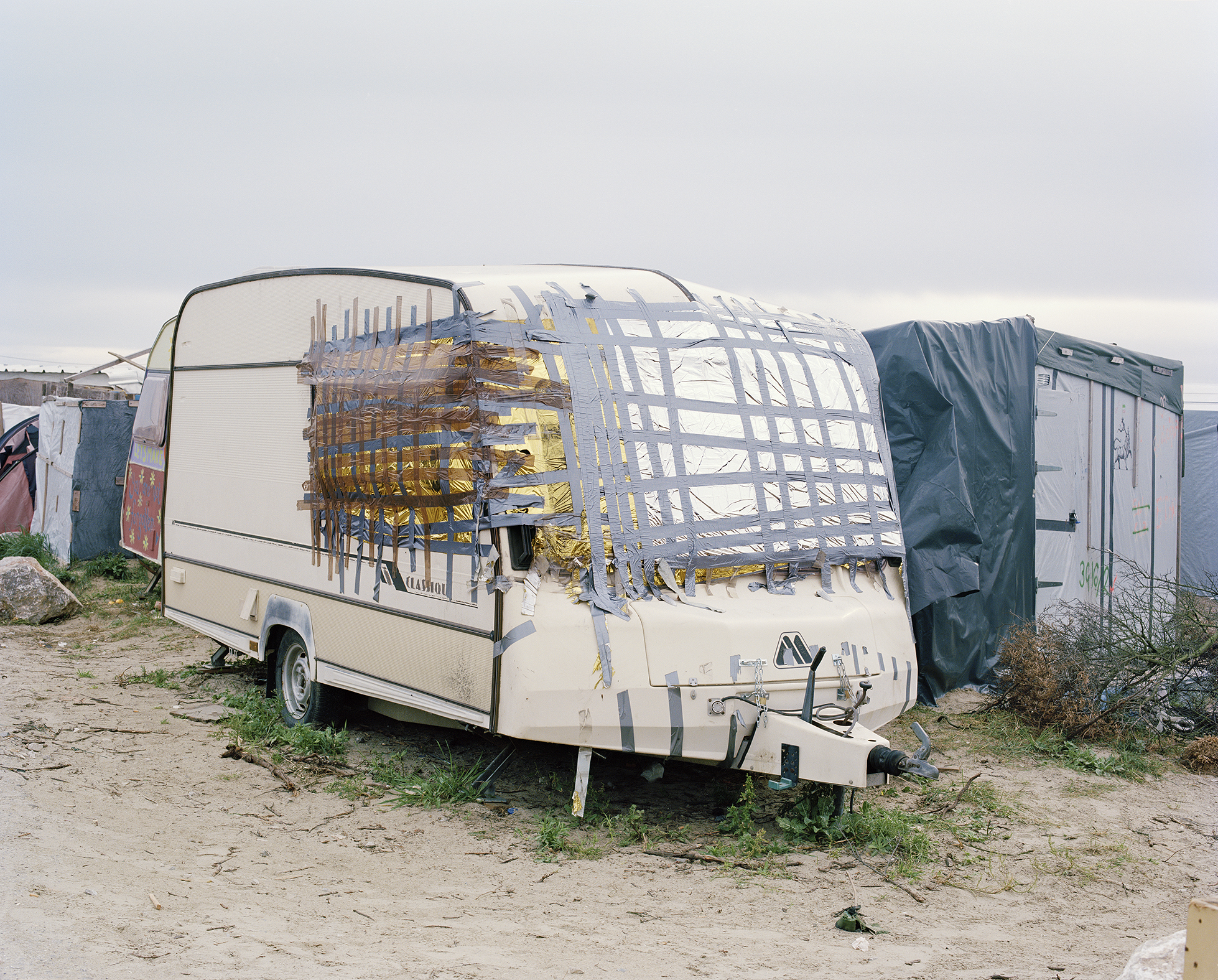 Photograph taken by Elisa Larvego of a caravan with the windows taped up.